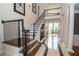 Elegant foyer featuring a striking staircase, marble floors, and soaring ceilings at 4054 Lyon Blvd, Atlanta, GA 30331