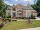 Beautiful two story home with brick and stucco exterior, manicured lawn, and tasteful landscaping at 4054 Lyon Blvd, Atlanta, GA 30331