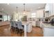 Open kitchen with white cabinets, granite counters, island seating, and stainless steel appliances at 4054 Lyon Blvd, Atlanta, GA 30331