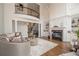 Bright living room with fireplace, hardwood floors, and staircase access to the second floor balcony at 4054 Lyon Blvd, Atlanta, GA 30331