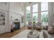 Bright living room featuring a fireplace, hardwood floors, high ceilings, and three large picture windows at 4054 Lyon Blvd, Atlanta, GA 30331