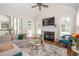 Cozy living room with vaulted ceiling, fireplace, large TV, comfortable seating and access to the outdoor patio at 4054 Lyon Blvd, Atlanta, GA 30331
