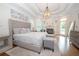 Comfortable main bedroom with tray ceiling, fireplace, ensuite, and hardwood floors at 4054 Lyon Blvd, Atlanta, GA 30331