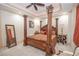Luxurious main bedroom features four poster bed, neutral carpet and elegant furnishings at 4054 Lyon Blvd, Atlanta, GA 30331