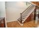 Elegant staircase with wooden steps, iron railings, and paneled walls at 4054 Lyon Blvd, Atlanta, GA 30331