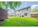 A spacious backyard with a wooden shed, green grass and a partial view of the home at 4815 Price St, Forest Park, GA 30297