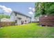 A backyard with wooden shed, green grass and a partial view of the home at 4815 Price St, Forest Park, GA 30297