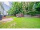 Fenced backyard with green grass and a wooden storage shed at 4815 Price St, Forest Park, GA 30297