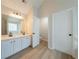 Bright bathroom with double vanity, a large mirror, and wood-look flooring at 4815 Price St, Forest Park, GA 30297