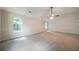 Bedroom featuring carpet, trim detail, and two sunlit windows at 4815 Price St, Forest Park, GA 30297