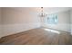 Bright dining room featuring wainscoting, modern chandelier, large window, and new flooring at 4815 Price St, Forest Park, GA 30297