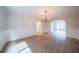 Open-concept dining room featuring modern chandelier and light wood-look flooring at 4815 Price St, Forest Park, GA 30297