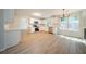 Modern kitchen with stainless appliances, white cabinets, new floor, and open layout connected to dining area at 4815 Price St, Forest Park, GA 30297