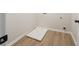 A compact laundry area with wood-look flooring and essential utility connections at 4815 Price St, Forest Park, GA 30297