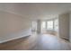 Sunlit living room with hardwood floors, large windows, and arched doorway at 4815 Price St, Forest Park, GA 30297