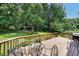 Deck with a seating area and a grill perfect for entertaining guests and enjoying the view of the backyard at 180 Kim Trail Trl, Stockbridge, GA 30281