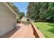Lovely outdoor deck with seating and a manicured lawn for relaxing or entertaining in the backyard at 180 Kim Trail Trl, Stockbridge, GA 30281