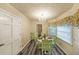 This dining area boasts a decorative chandelier, bright window, and attractive flooring at 180 Kim Trail Trl, Stockbridge, GA 30281
