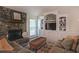 Cozy living room area with a stone fireplace, built-in shelves, and comfortable seating at 180 Kim Trail Trl, Stockbridge, GA 30281