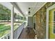 Inviting covered front porch with stone accents and outdoor seating, perfect for relaxing at 180 Kim Trail Trl, Stockbridge, GA 30281