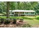 Charming single story home with manicured front yard, stone accents, and mature trees at 180 Kim Trail Trl, Stockbridge, GA 30281