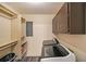 The laundry room includes a modern washer and dryer, storage shelves, and practical flooring at 180 Kim Trail Trl, Stockbridge, GA 30281