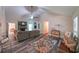 Spacious living room featuring a stone fireplace, vaulted ceilings, and stylish decor at 180 Kim Trail Trl, Stockbridge, GA 30281