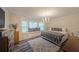 Spacious main bedroom featuring a cozy window seat, decorative lighting, and chic flooring at 180 Kim Trail Trl, Stockbridge, GA 30281