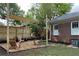 Backyard with a shade sail, lounge chairs, wooden fence and landscaping at 1134 Donnelly Sw Ave, Atlanta, GA 30310