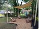 Outdoor seating area with wooden chairs and a sun shade, perfect for relaxing at 1134 Donnelly Sw Ave, Atlanta, GA 30310