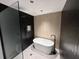 Bathroom featuring a black tiled shower, soaking tub, and modern fixtures at 1134 Donnelly Sw Ave, Atlanta, GA 30310