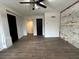 Spacious bedroom showcasing tiled floors, a ceiling fan, and an exposed brick wall at 1134 Donnelly Sw Ave, Atlanta, GA 30310