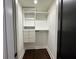 White walk-in closet featuring built-in shelving and drawers on dark hardwood flooring at 1134 Donnelly Sw Ave, Atlanta, GA 30310