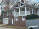 Two-story brick home with a covered porch and a gray garage at 1134 Donnelly Sw Ave, Atlanta, GA 30310