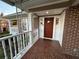 Inviting front porch featuring brick flooring and a charming 'hello' welcome mat at 1134 Donnelly Sw Ave, Atlanta, GA 30310