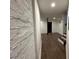 Hallway featuring tiled floors, white walls, and a black door ahead at 1134 Donnelly Sw Ave, Atlanta, GA 30310