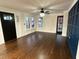 Bright and open living room featuring hardwood floors, stylish ceiling fan, and accent wall at 1134 Donnelly Sw Ave, Atlanta, GA 30310