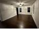 Spacious living room features hardwood floors, natural light, ceiling fan and a barn door at 1134 Donnelly Sw Ave, Atlanta, GA 30310