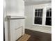 Bright living room with a painted brick fireplace, hardwood floors and large windows at 1134 Donnelly Sw Ave, Atlanta, GA 30310