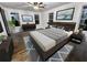 Main bedroom with hardwood floors, neutral decor, large bed, and two windows at 1134 Donnelly Sw Ave, Atlanta, GA 30310