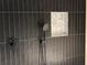 Modern black tiled shower featuring a rain shower head and built-in niche at 1134 Donnelly Sw Ave, Atlanta, GA 30310