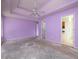 Spacious primary bedroom featuring a tray ceiling, ceiling fan, and ensuite bathroom at 148 Barrington Pkwy, Stockbridge, GA 30281
