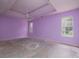 Spacious bedroom with tray ceilings, neutral walls, and large windows offering natural light at 148 Barrington Pkwy, Stockbridge, GA 30281