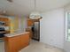 Kitchen with stainless steel appliances, an island, and a window offering natural light and backyard views at 148 Barrington Pkwy, Stockbridge, GA 30281