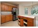 Kitchen featuring wood cabinets, an island, and windows offering natural light with backyard views at 148 Barrington Pkwy, Stockbridge, GA 30281
