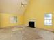 A spacious room with a fireplace, high ceilings, and natural light offers comfort and relaxation at 148 Barrington Pkwy, Stockbridge, GA 30281