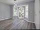 Bright bedroom featuring large windows, hardwood floors, neutral paint, and unique lighting at 2773 Hawk Trace Ne Ct, Marietta, GA 30066