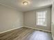Cozy bedroom showcasing laminate floors and a single window at 2773 Hawk Trace Ne Ct, Marietta, GA 30066