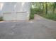 A shot of a long concrete driveway leading to a two-car garage of this home at 2773 Hawk Trace Ne Ct, Marietta, GA 30066