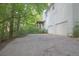 Exterior angle of a two-story house showing the garage and side yard with mature trees at 2773 Hawk Trace Ne Ct, Marietta, GA 30066